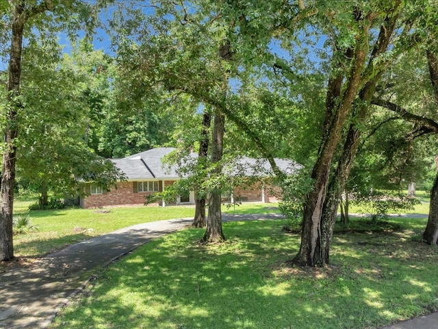 200 Platt Rd, Lufkin, TX 75904 - view of front facade with driveway, a front lawn, and brick siding