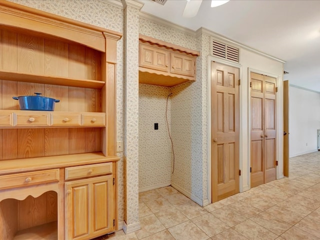 interior space featuring light tile patterned floors, crown molding, wallpapered walls, and baseboards