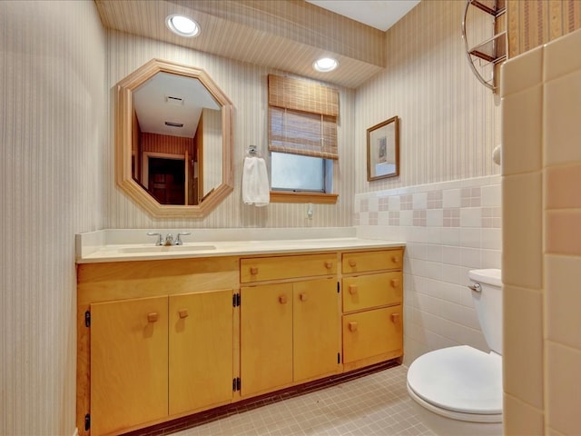 bathroom with tile patterned floors, vanity, toilet, and wallpapered walls