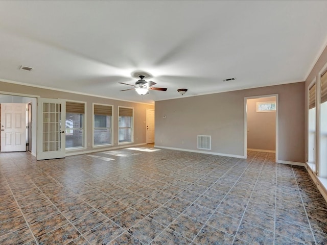 unfurnished living room with a ceiling fan, visible vents, and baseboards