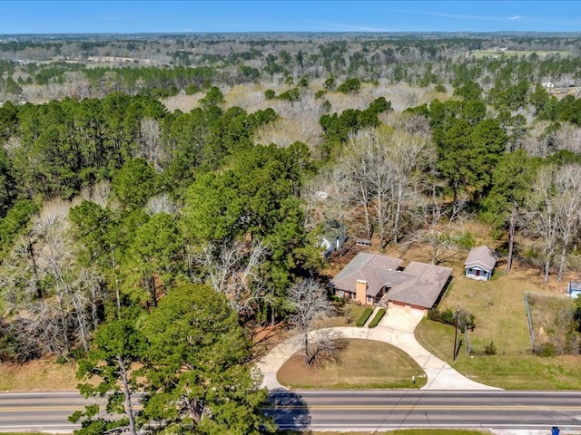 birds eye view of property with a forest view