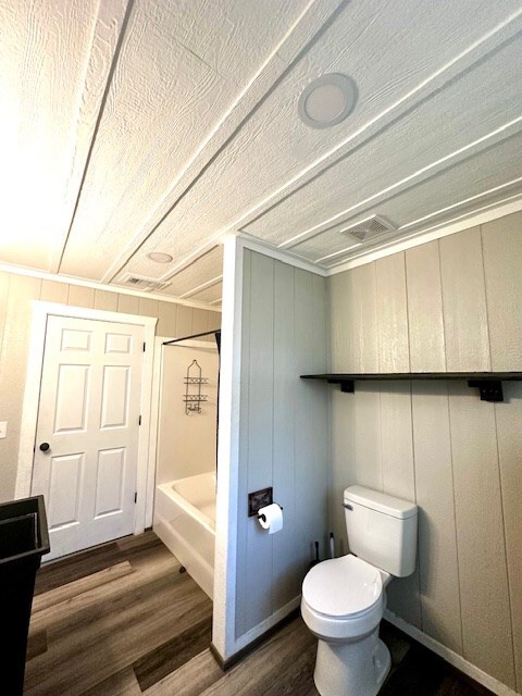 308 Pine, Diboll, TX 75941 - bathroom featuring toilet, shower / tub combination, and wood finished floors