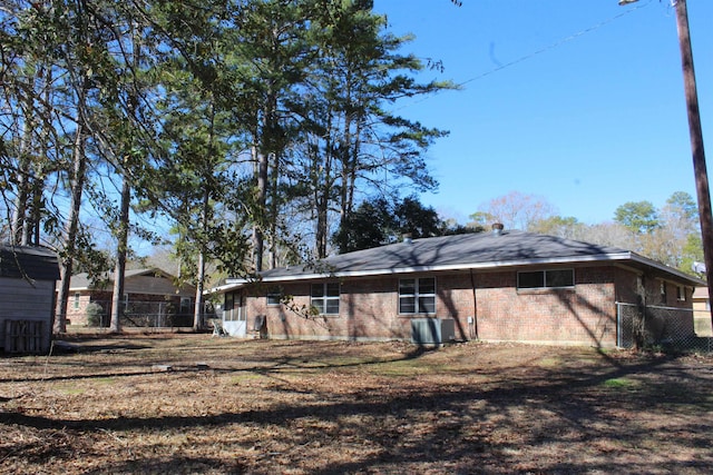 back of property featuring central air condition unit