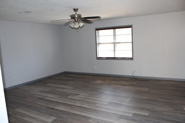 unfurnished room featuring a textured ceiling, ceiling fan, and dark hardwood / wood-style floors