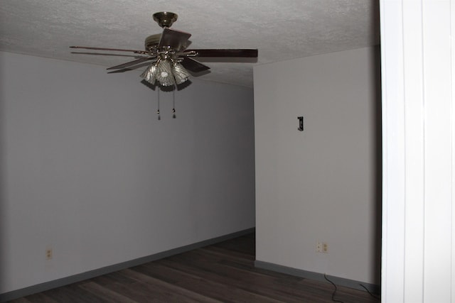 unfurnished room featuring a textured ceiling, dark hardwood / wood-style floors, and ceiling fan