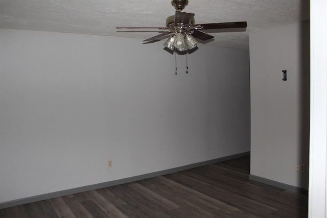 unfurnished room featuring a textured ceiling, dark hardwood / wood-style floors, and ceiling fan