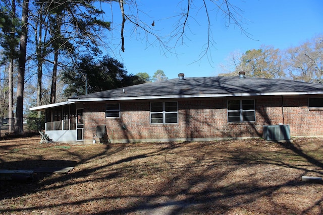 back of property with a lawn, central AC, and a sunroom