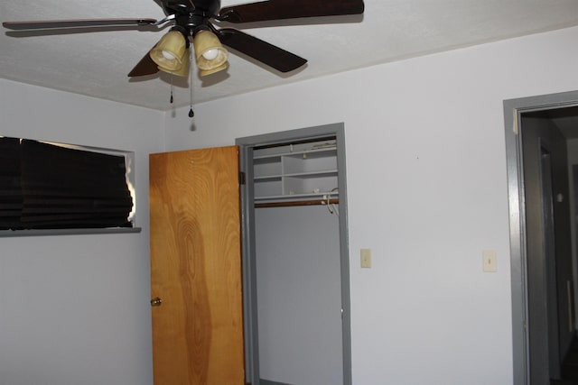 unfurnished bedroom featuring a closet and ceiling fan