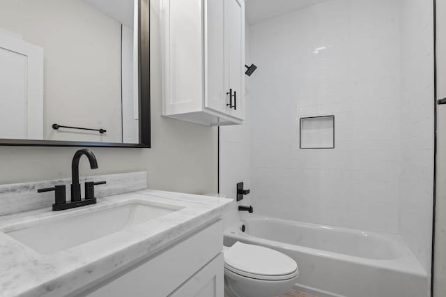 full bathroom featuring vanity, toilet, and tiled shower / bath