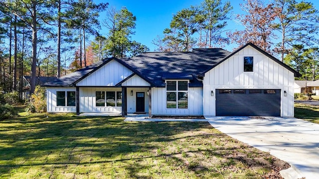 modern inspired farmhouse featuring a garage and a front yard