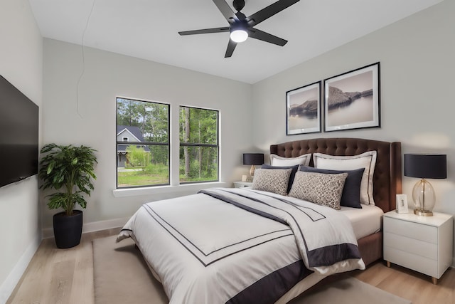 bedroom with light hardwood / wood-style floors and ceiling fan