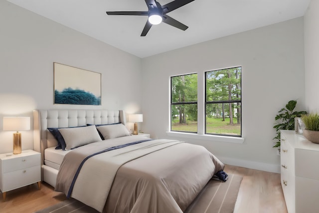 bedroom with wood-type flooring and ceiling fan