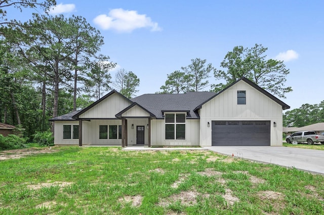 modern farmhouse with a garage and a front lawn