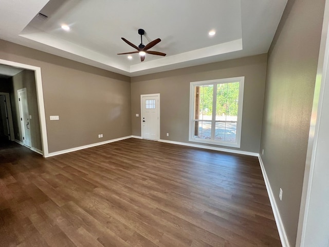 105 Cooper Rd, Zavalla, TX 75980 - unfurnished room with a tray ceiling, dark wood-style flooring, a ceiling fan, and recessed lighting