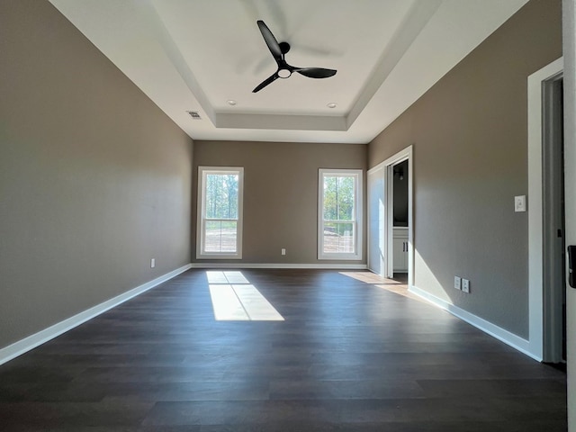 105 Cooper Rd, Zavalla, TX 75980 - spare room featuring a tray ceiling, dark wood-style floors, and a ceiling fan