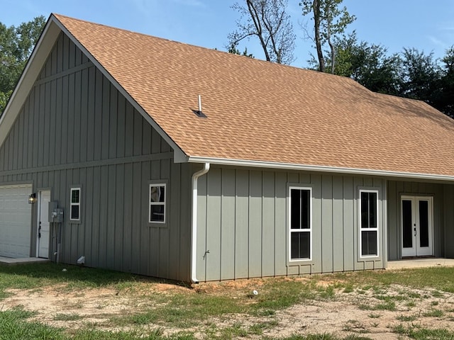105 Cooper Rd, Zavalla, TX 75980 - view of home's exterior with french doors, roof with shingles, a garage, and board and batten siding