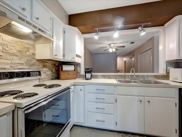 kitchen with decorative backsplash, a textured ceiling, sink, electric range, and white cabinets