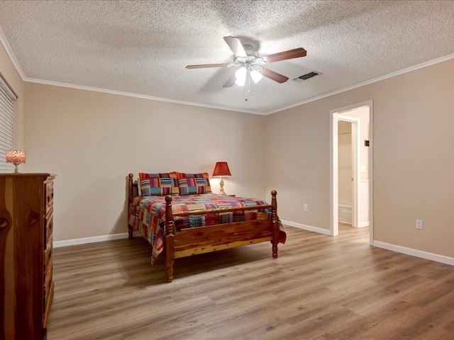 bedroom featuring ceiling fan, light hardwood / wood-style floors, ornamental molding, and a textured ceiling