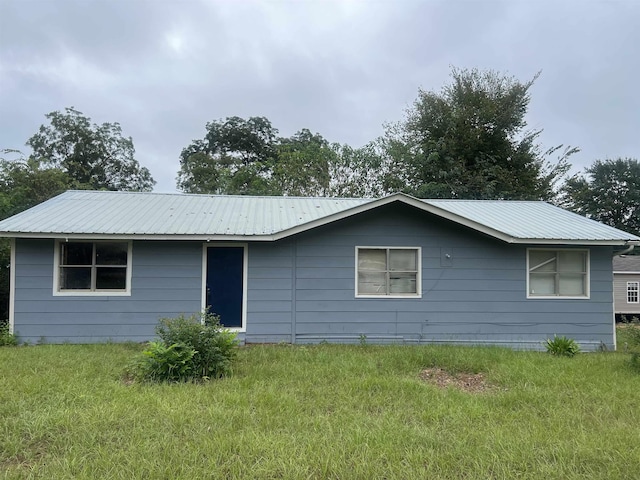 back of property with a lawn