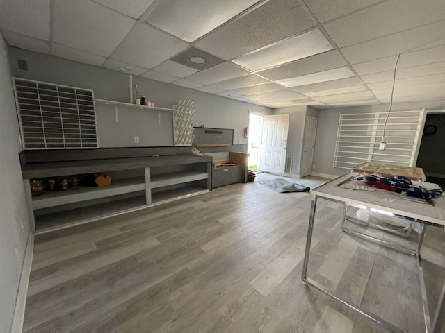 kitchen with hardwood / wood-style floors and a drop ceiling