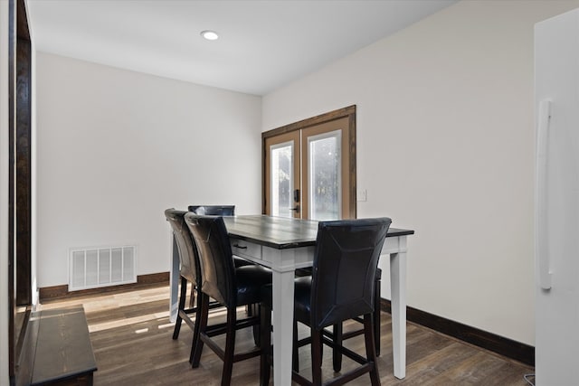 dining room featuring french doors and dark hardwood / wood-style flooring