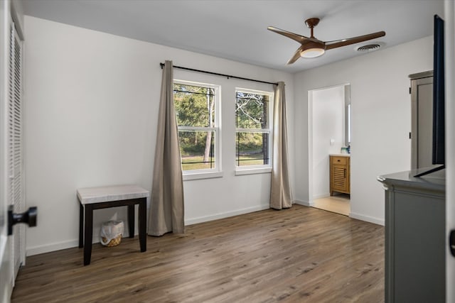 interior space featuring ceiling fan, dark hardwood / wood-style flooring, and ensuite bathroom