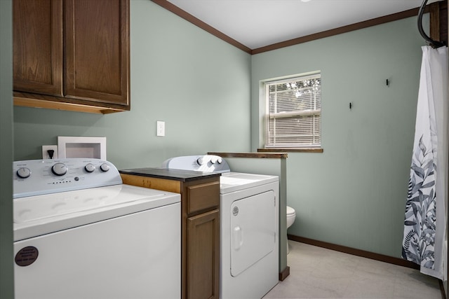 washroom with washing machine and dryer and ornamental molding