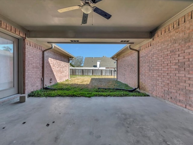 view of patio featuring ceiling fan and fence