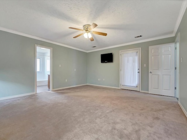 unfurnished room featuring light carpet, ornamental molding, visible vents, and a ceiling fan