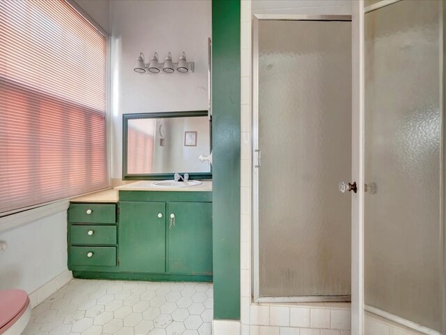 bathroom featuring vanity and a shower with shower door