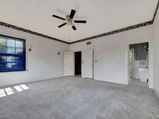 carpeted empty room with plenty of natural light and ceiling fan