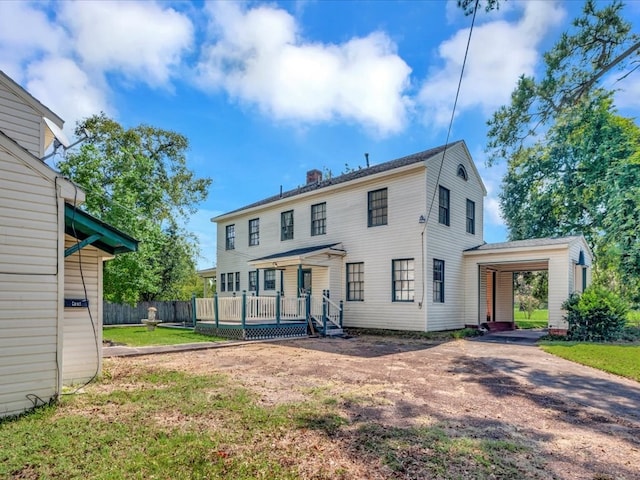 back of property with a lawn