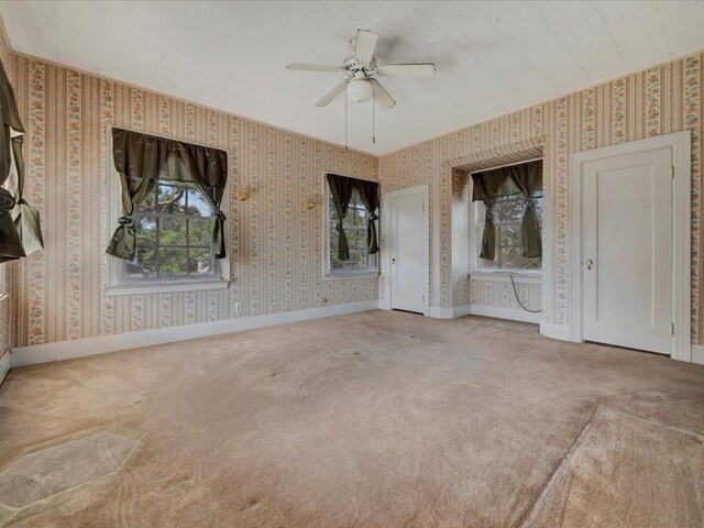 unfurnished bedroom with ceiling fan and carpet floors