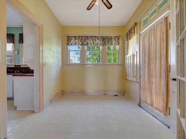 unfurnished room with ceiling fan