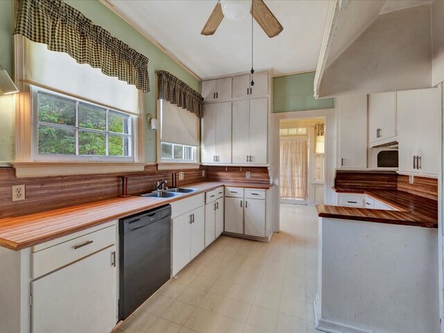 kitchen featuring sink, white cabinetry, and black dishwasher