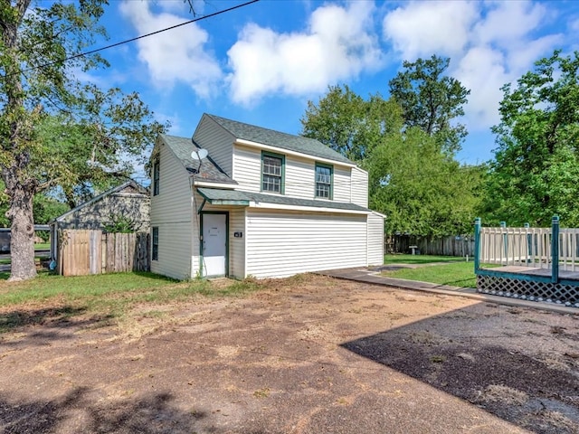 exterior space featuring a front yard and a deck