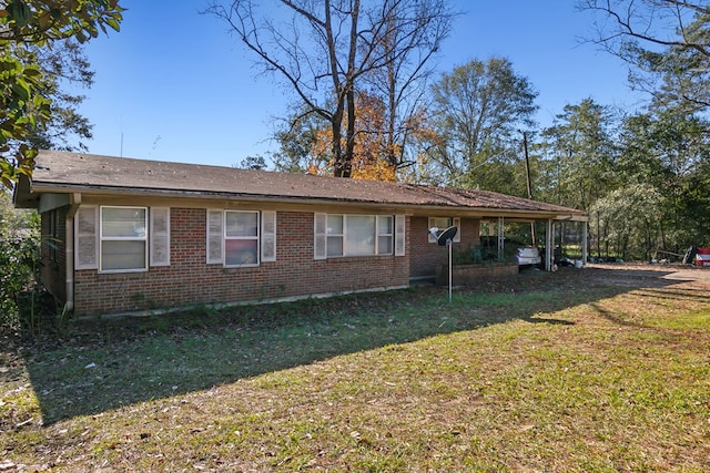 view of front facade with brick siding and a front yard