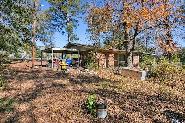 rear view of house with an attached carport