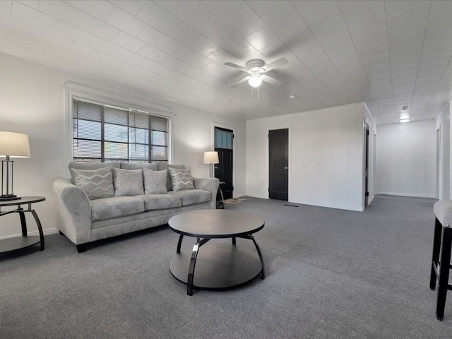 carpeted living room with ceiling fan