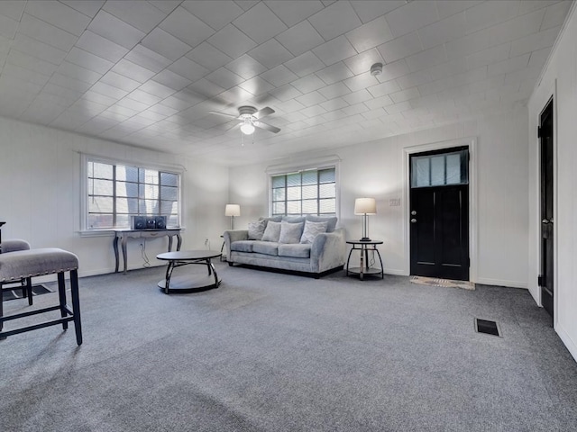 carpeted living room featuring ceiling fan