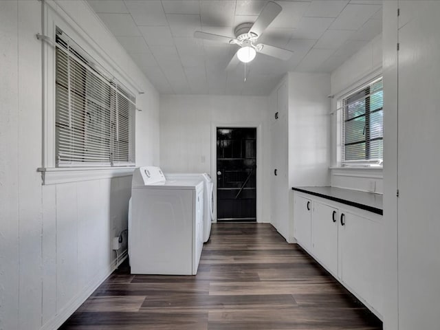 clothes washing area with washer and dryer, ceiling fan, and dark wood-type flooring