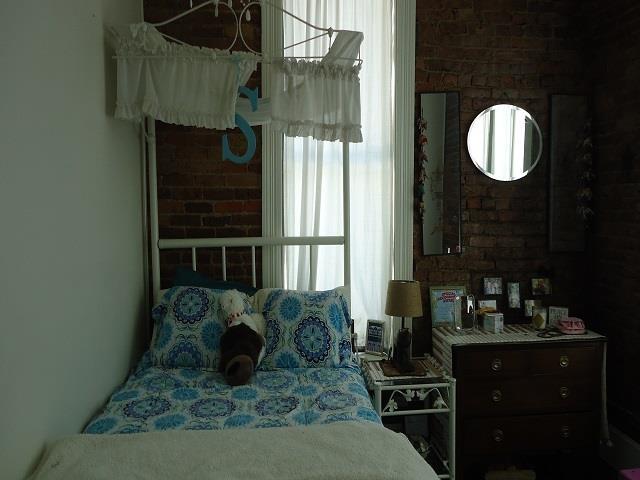 152 N Oak St, Hemphill, TX 75948 - bedroom featuring brick wall