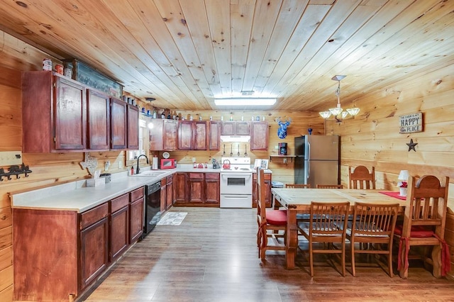 kitchen featuring dishwasher, a sink, freestanding refrigerator, electric stove, and under cabinet range hood