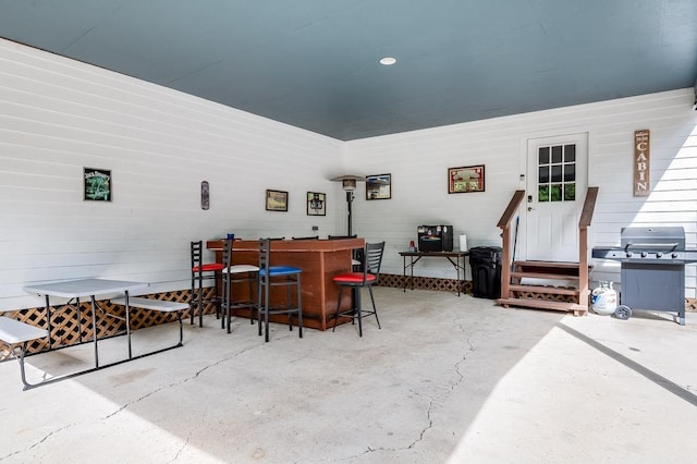 interior space with a bar and concrete floors
