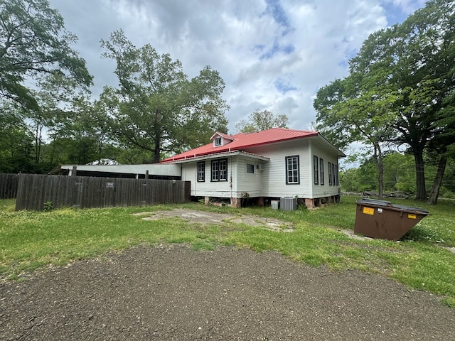 805 Worth St, Hemphill, TX 75948 - view of home's exterior with fence, cooling unit, and metal roof