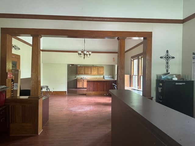 805 Worth St, Hemphill, TX 75948 - interior space with decorative light fixtures, an inviting chandelier, dark wood-style flooring, a peninsula, and brown cabinets