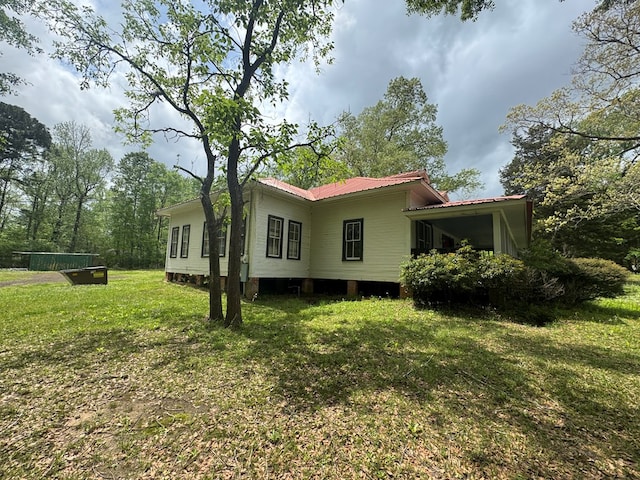 805 Worth St, Hemphill, TX 75948 - view of home's exterior with a yard and metal roof