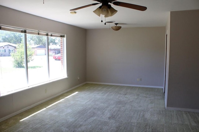 spare room with carpet and ceiling fan