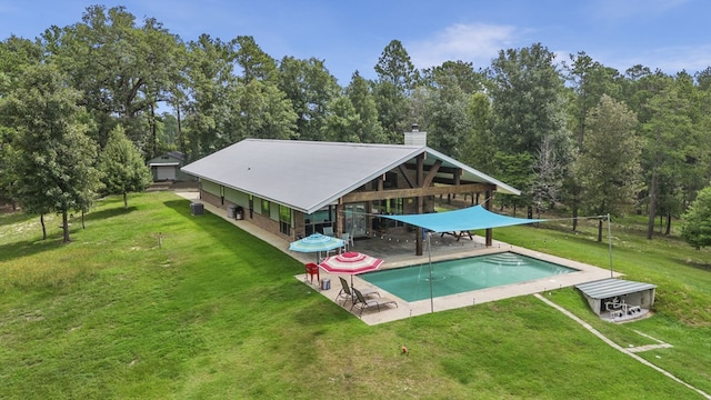 rear view of house featuring a patio area and a yard