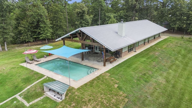 view of swimming pool featuring a yard and a patio